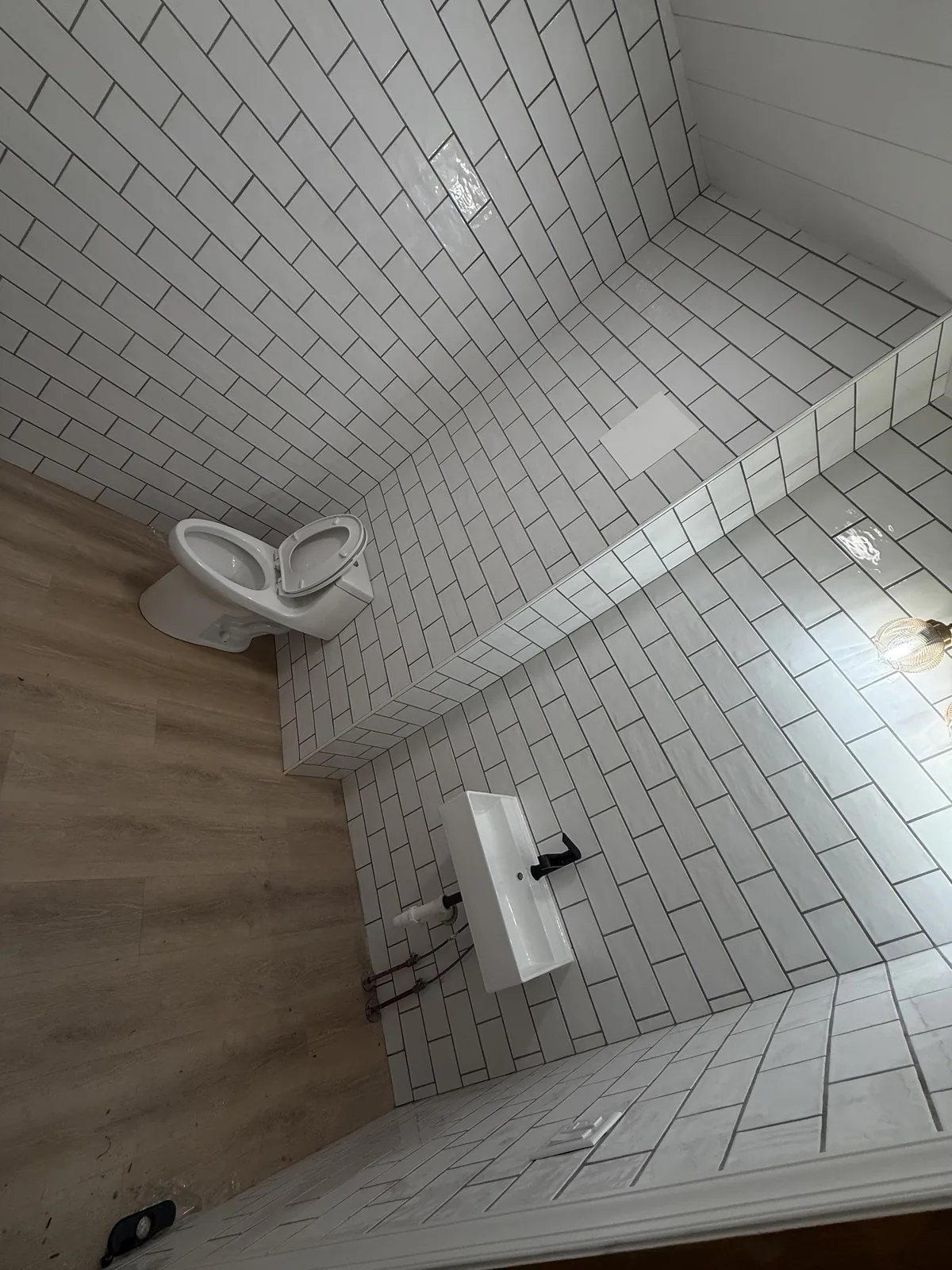 Bathroom with toilet and wall-mounted sink installed