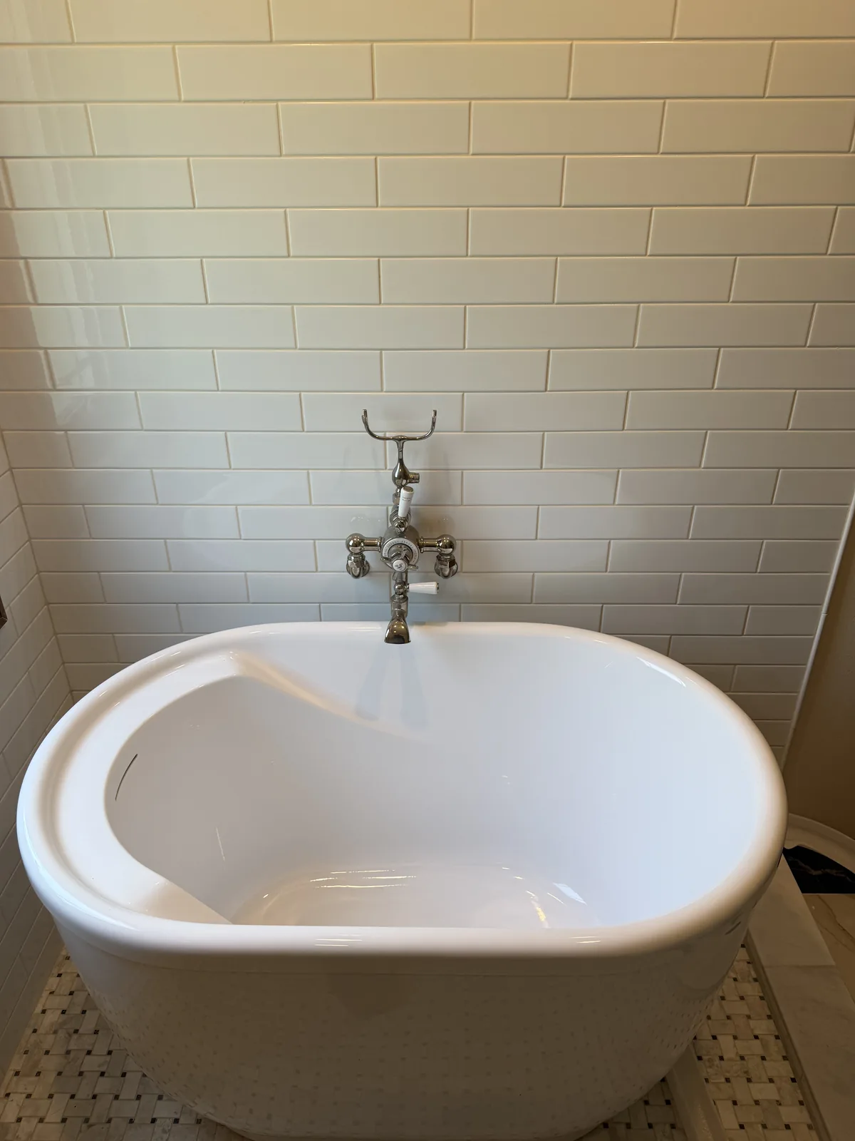 Close-up of a freestanding tub and wall-mounted faucet