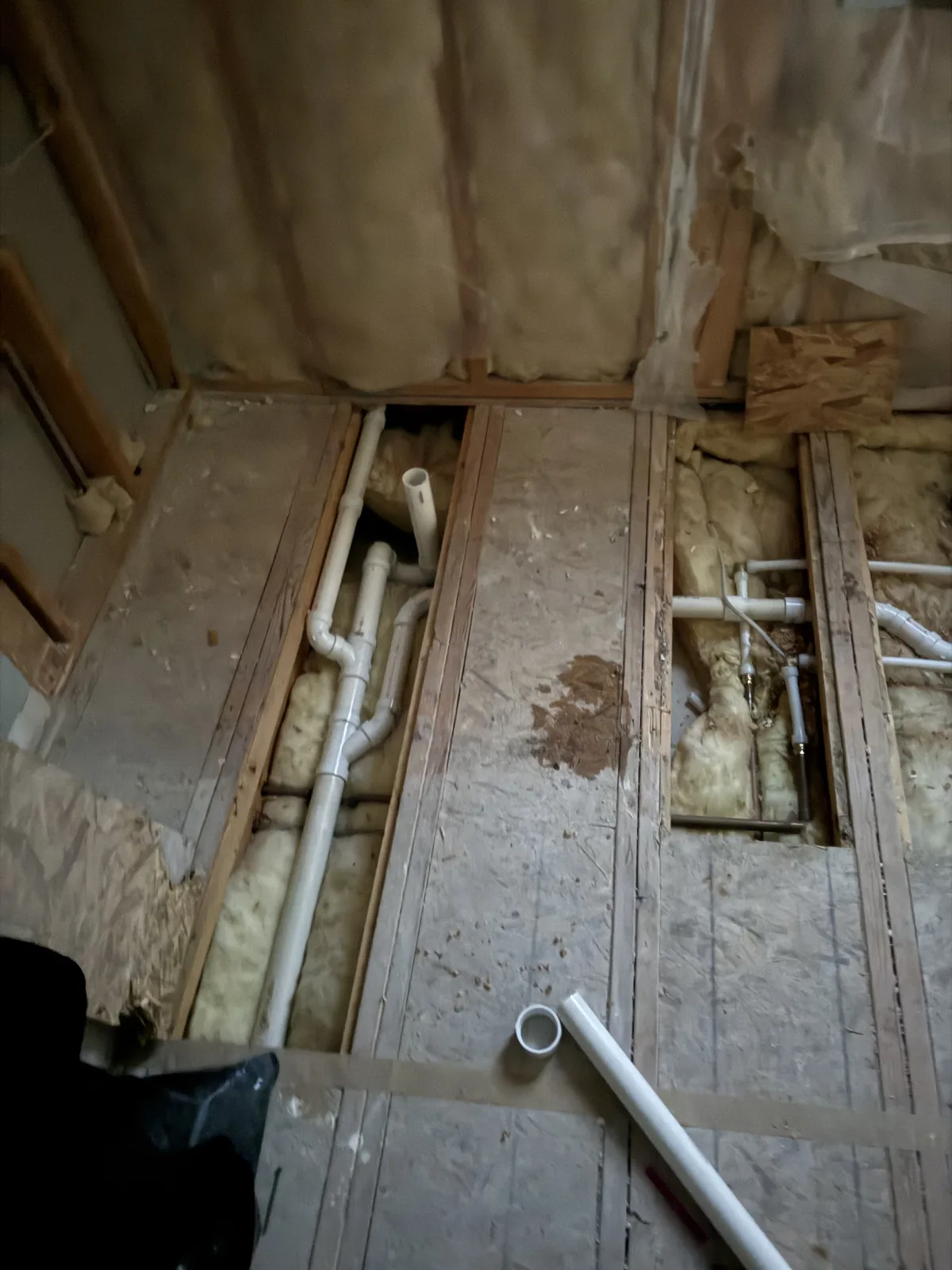 PVC drain lines installed in an opened bathroom floor