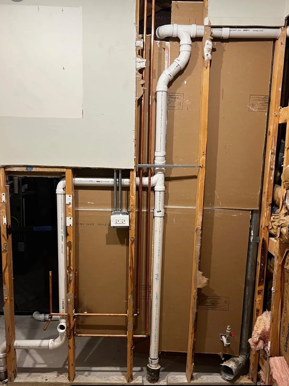 PVC drain and vent stack roughed in inside an open wall