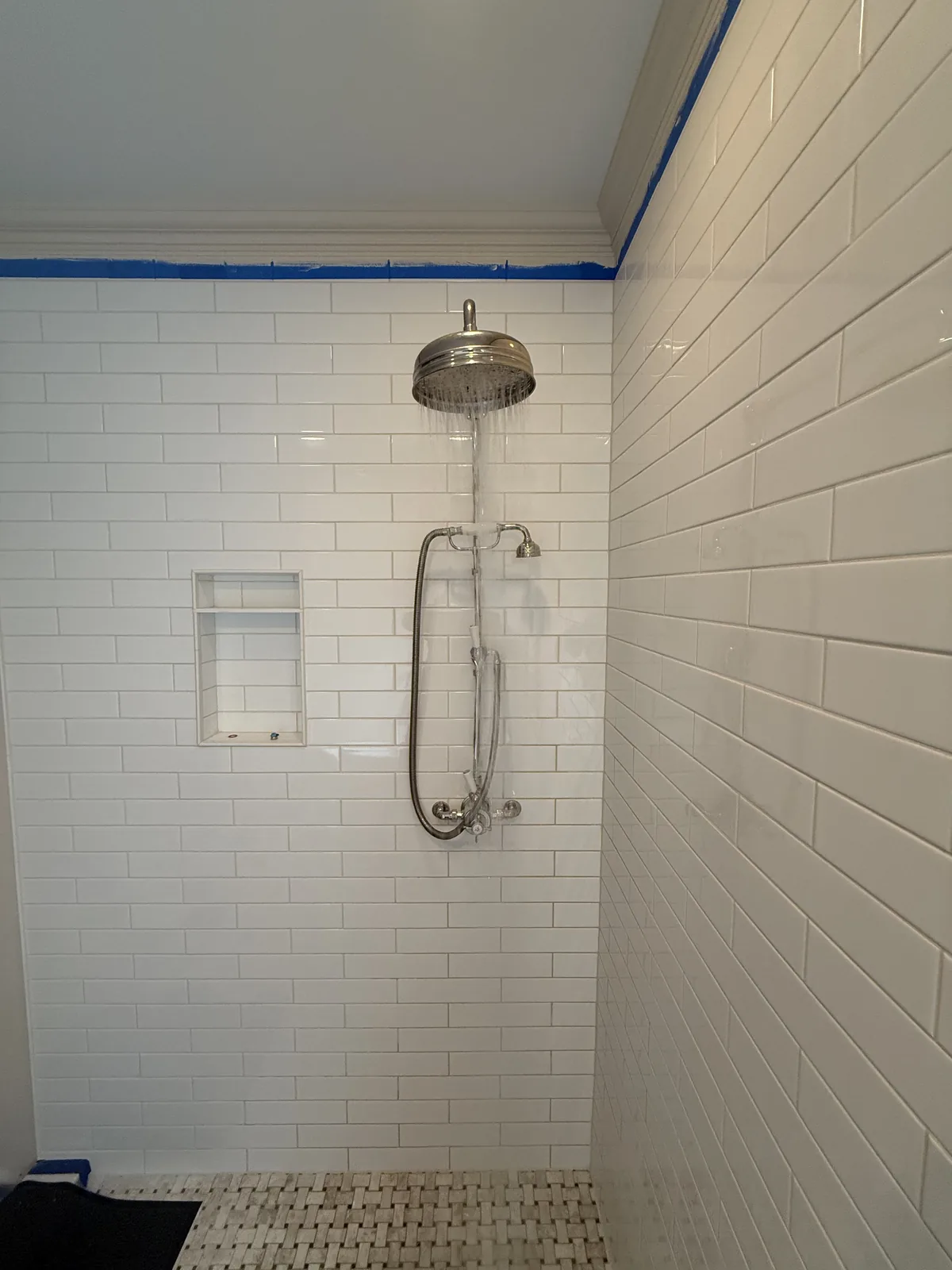 Walk-in shower with rain head and handheld shower