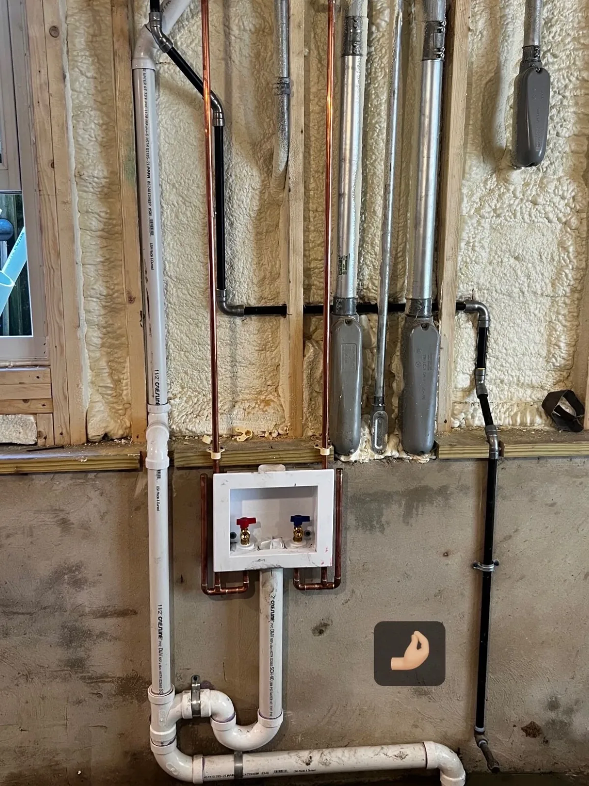 Washer box with PVC drain roughed in on a basement wall